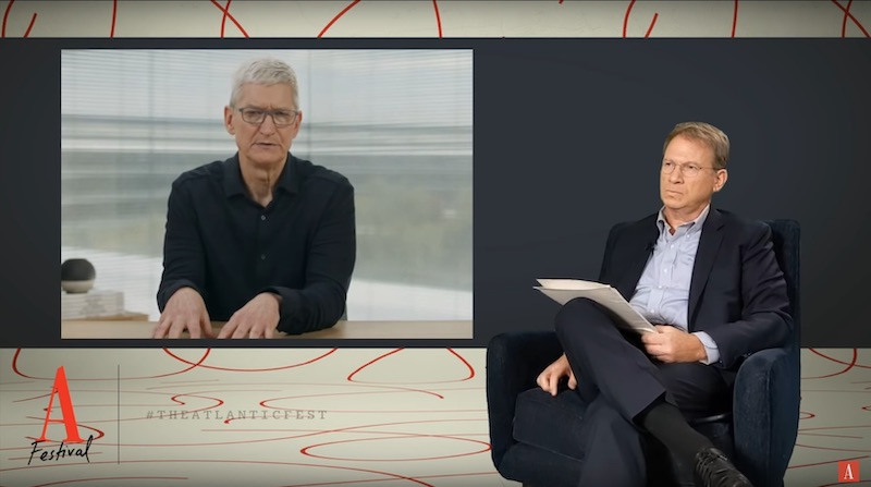 Apple CEO Tim Cook showing good video-call planning. Camera at eye level. Looking down the camera lens. More than just the face visible. Boring background.
